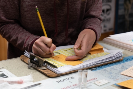 A researcher takes notes at the Escanaba Check In Station