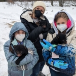 Snapshot volunteers keep cubs warm during a bear den survey.