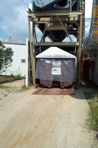 A covered roll-off dumpster.