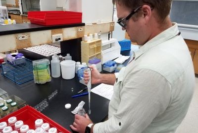 A man working in a laboratory with lab samples