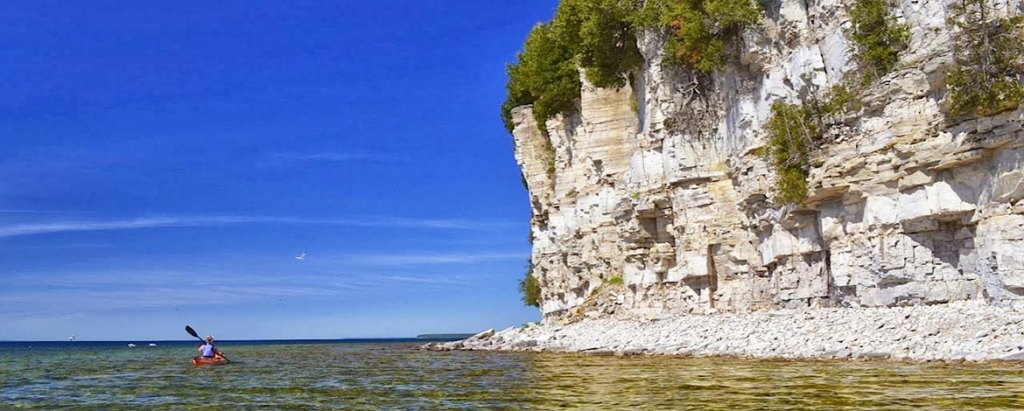 Kayaker along the shoreline at Rock Island State Park.