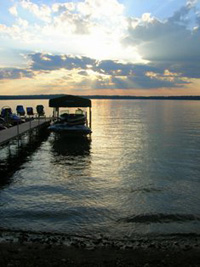 A boat at a dock on Crawling Stone Lake, Lac du Flambeau at sunset.