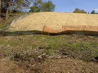 Water breaking through an earthen bank