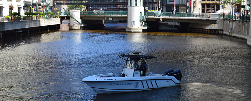 Wardens patrolling a river in downtown Milwaukee.